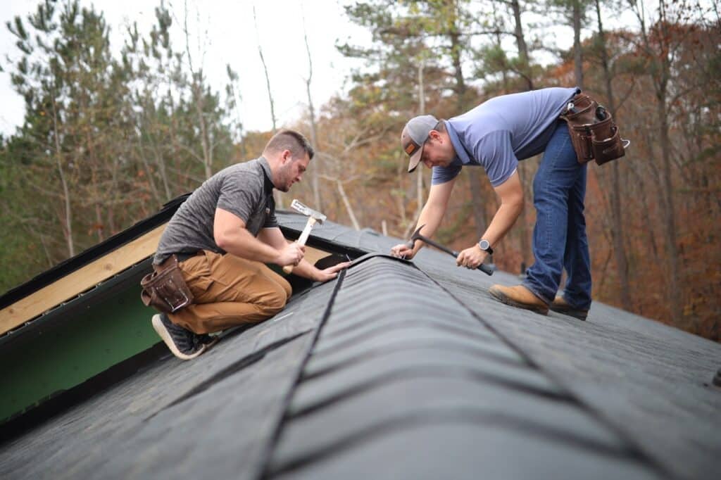 an image of two ProRoofing team member completing roof repairs